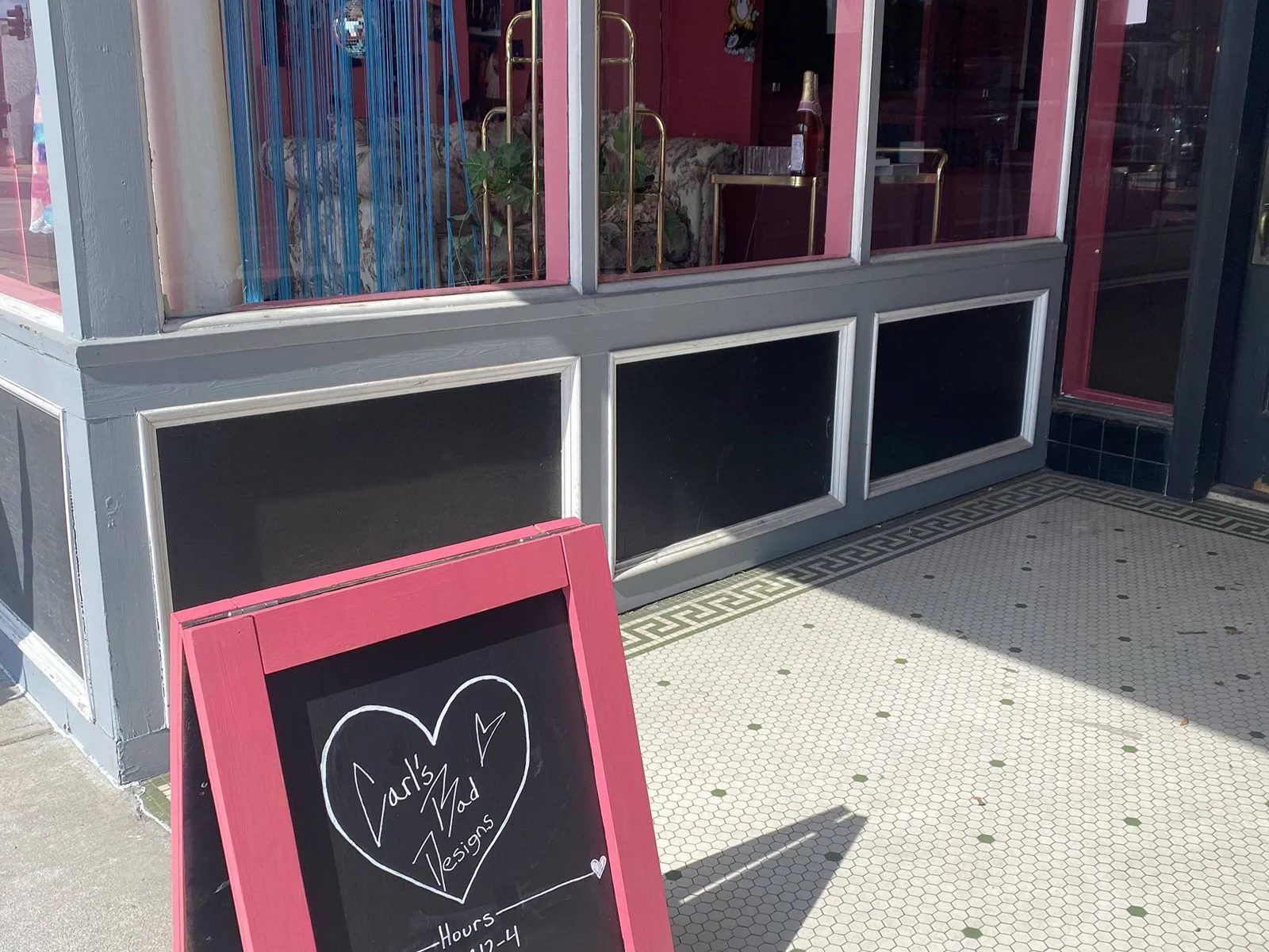 The storefront and mosaic-tile entry on Campbell Ave